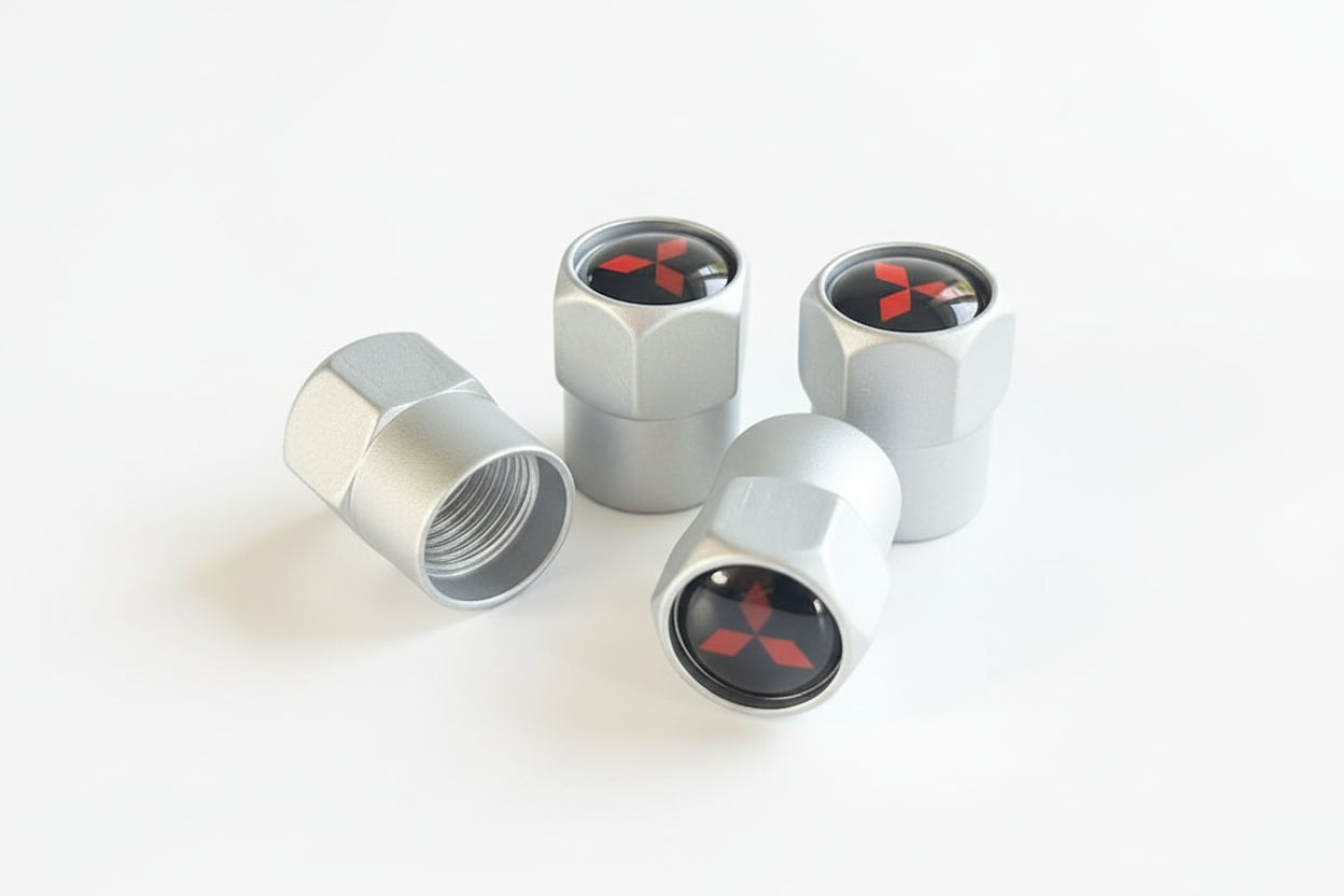 Four metal valve stem caps with a logo on a white background.